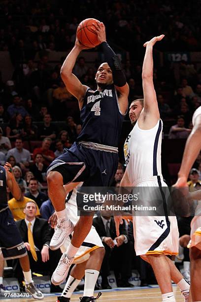 Cam Thoroughman of the West Virginia Mountaineers defends Chris Wright of the Georgetown Hoyas goes tp the hoop during the championship of the 2010...