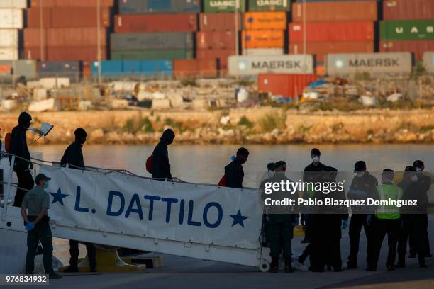 Migrants disembark from the Italian coast guard vessel Dattilo at the Port of Valencia on June 17, 2018 in Valencia, Spain. The Aquarius rescue ship...