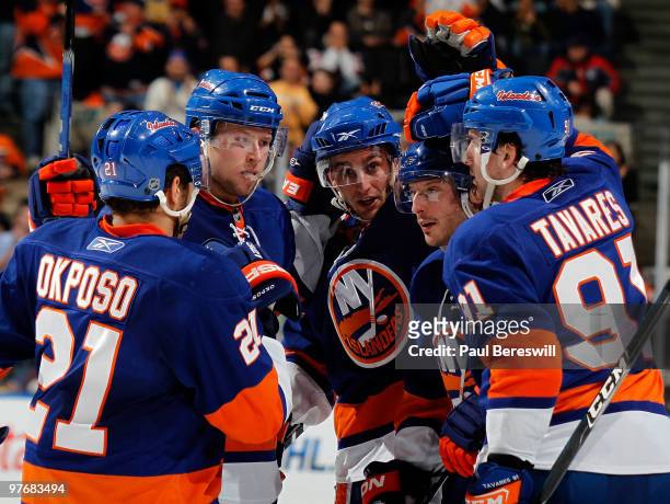 Kyle Okposo, Josh Bailey and Frans Nielsen congratulate teammate Mark Streit along with John Tavares of the New York Islanders as they celebrate a...