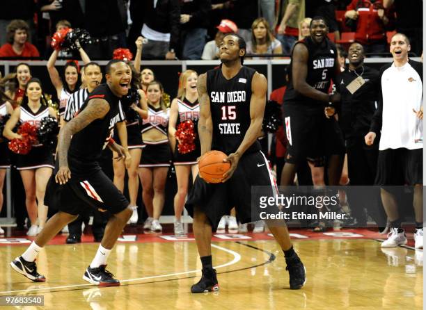 Billy White celebrates and Kawhi Leonard of the San Diego State Aztecs tosses the ball up as time expires in their 55-45 victory over the UNLV Rebels...