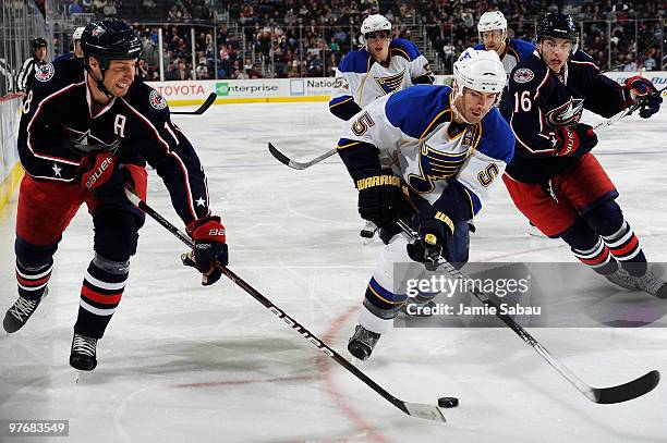 Barret Jackman of the St. Louis Blues skates past R.J. Umberger and Derick Brassard, both of the Columbus Blue Jackets, during the third period on...