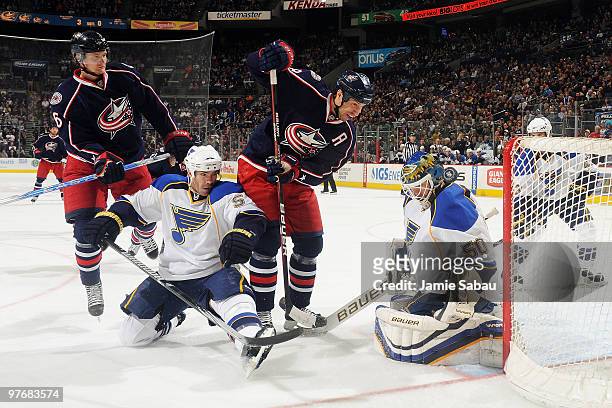 Anton Stralman and R.J. Umberger, both of the Columbus Blue Jackets, battle for positioning in front of Barret Jackman and goaltender Chris Mason,...