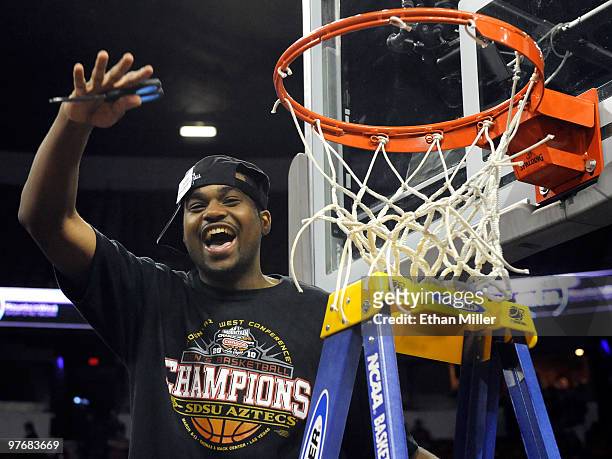 Chase Tapley of the San Diego State Aztecs cuts down the net after defeating the UNLV Rebels 55-45 in the championship game of the Conoco Mountain...