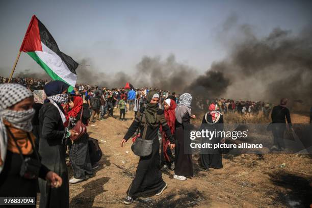 Dpatop - Palestinian girls take part in clashes with Israeli security forces along the Israel-Gaza border, east of Gaza City, Gaza Strip, 13 April...