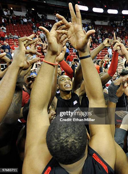 Malcolm Thomas of the San Diego State Aztecs and his teammates celebrate on the court after defeating the UNLV Rebels 55-45 in the championship game...