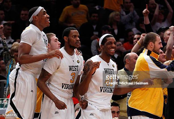 Kevin Jones, Devin Ebanks and John Flowers of the West Virginia Mountaineers react from the bench against the Georgetown Hoyas during the...