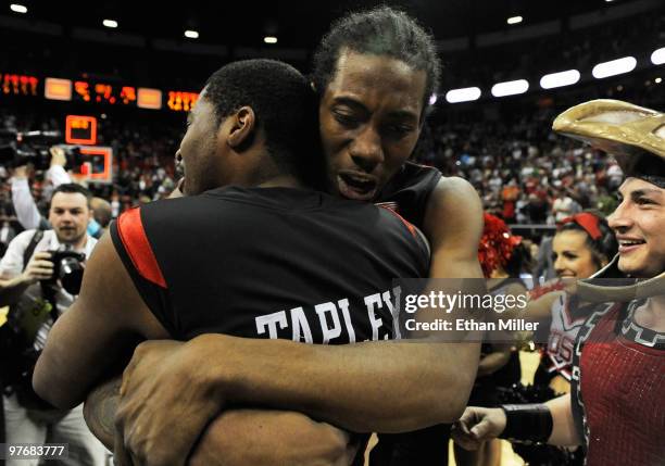 Kawhi Leonard of the San Diego State Aztecs hugs teammate Chase Tapley as they celebrate on the court after defeating the UNLV Rebels 55-45 in the...