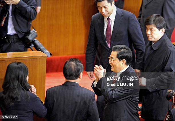 Chinese President Hu Jintao greets delegates after the closing session of the National People's Congress at the Great Hall of the People in Beijing...