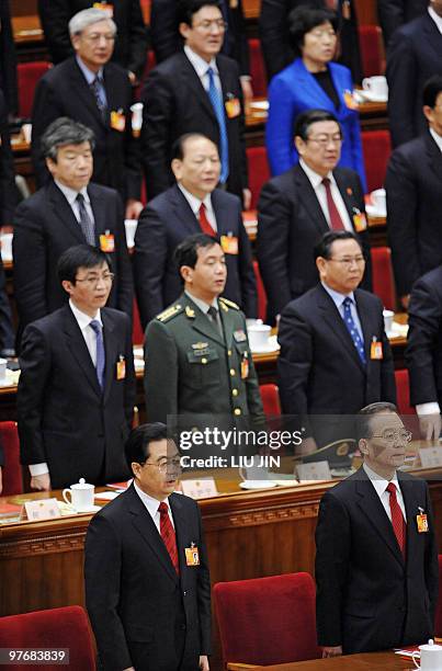 Chinese President Hu Jintao and Chinese Premier Wen Jiabao sing the national anthem at the end of the closing session of the National People's...