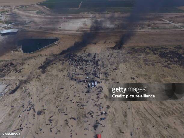 Dpatop - An aerial view of columns of smoke rising from burnt tyres during clashes between Palestinian protesters and Israeli security forces along...