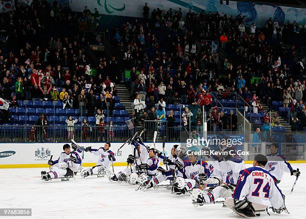 Fan cheer for team Korea after their 5-0 loss to the United States during the Ice Sledge Hockey Preliminary Round Group A Game between the United...
