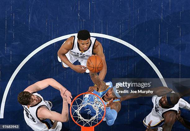 Carmelo Anthony of the Denver Nuggets shoots against Marc Gasol, Rudy Gay, and Zach Randolph of the Memphis Grizzlies on March 13, 2010 at FedExForum...