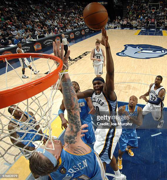 Zach Randolph of the Memphis Grizzlies shoots over Chris Andersen of the Denver Nuggets on March 13, 2010 at FedExForum in Memphis, Tennessee. NOTE...
