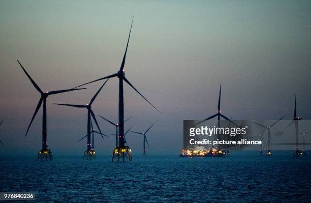 April 2018, Germany, Sassnitz: Offshore wind mills at the Baltic Sea wind park 'Wikinger' of energy supplier Iberdrola at the Baltic Sea in front of...
