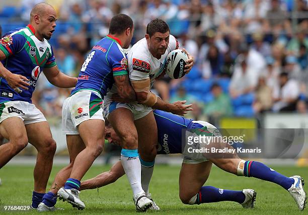 Mark Minichiello of the Titans attempts to push through the Warriors defence during the round one NRL match between the Gold Coast Titans and the...