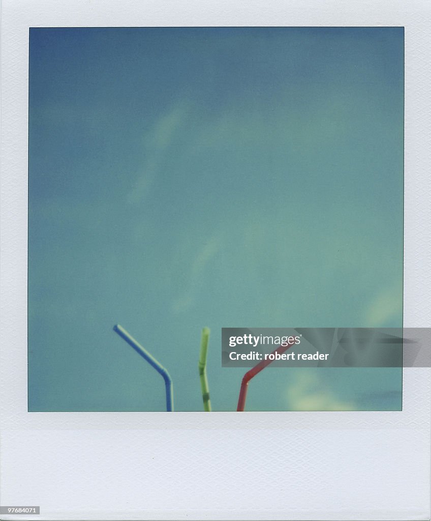 Polaroid of red, green, blue drinking straws