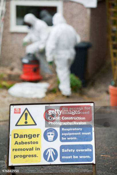 Specialist asbestos removal company removing asbestos from a shed roof of a house in Ambleside, Cumbria, UK.