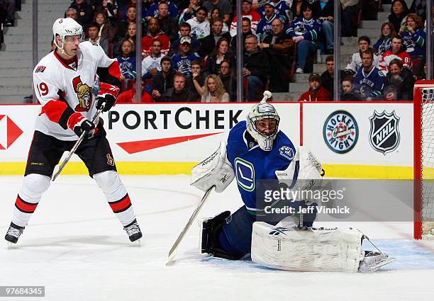 Roberto Luongo of the Vancouver Canucks makes a glove save off a shot by Jason Spezza of the Ottawa Senators during their game at General Motors...