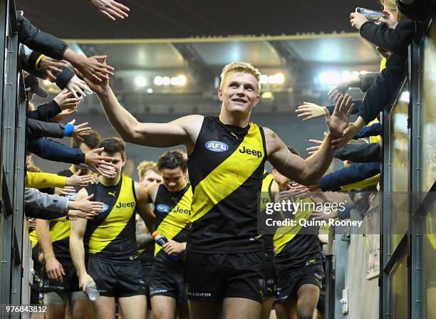 Ryan Garthwaite of the Tigers high fives fans after winning the round 13 AFL match between the Geelong Cats and the Richmond Tigers at Melbourne...