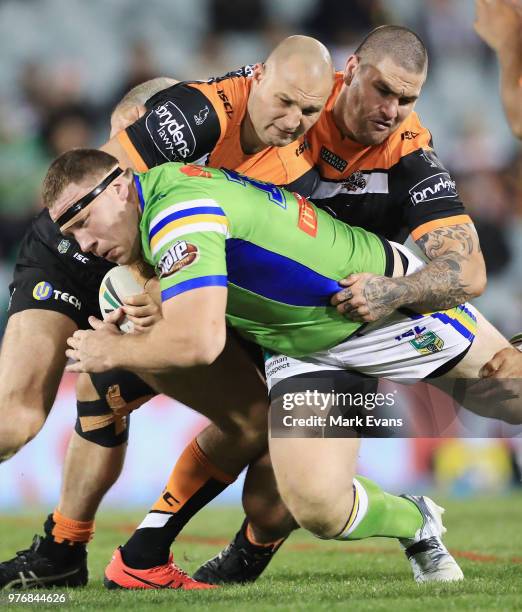 Shannon Boyd of the Raiders is tackled during the round 15 NRL match between the Wests Tigers and the Canberra Raiders at Campbelltown Sports Stadium...