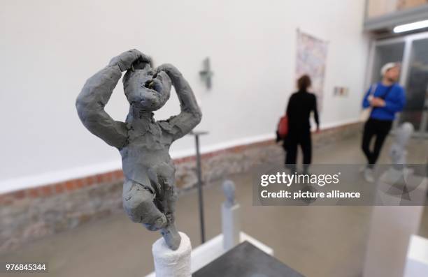 April 2018, Germany, Leipzig: Visitors of an exhibition take a look at the exhibited works on the occasion of the traditional spring tour at the...