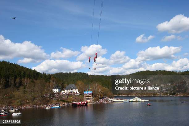 April 2018, Germany, Drognitz: High-wire artists of the 'Geschwister Weisheit' are on a motorbike and drive across the Hohenwarte reservoir on wire...