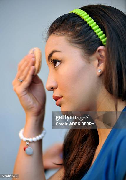 Indonesian Manohara Odelia Pinot prepares her make-up during a casting for her TV drama show in Jakarta on July 1, 2009. Manohara and her mother were...
