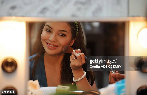Indonesian Manohara Odelia Pinot prepares her make-up during a casting for her TV drama show in Jakarta on July 1, 2009. Manohara and her mother were...