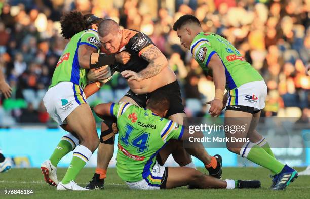 Russell Packer of the Tigers is tackled during the round 15 NRL match between the Wests Tigers and the Canberra Raiders at Campbelltown Sports...