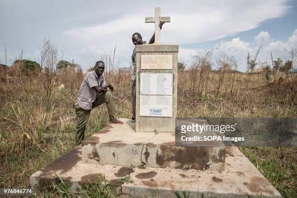 Local spokesperson stands by a monument to the 2004 massacre in Lukodi, when dozens of people were killed after the Lord's Resistance Army attacked...