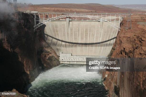 View of the water below the bridge. Water is released from the Glen Canyon Dam into the Colorado River below. The water and sand will replenish...