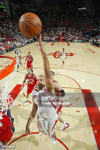 Shane Battier of the Houston Rockets shoots the ball over Brook Lopez of the New Jersey Nets on March 13, 2010 at the Toyota Center in Houston,...