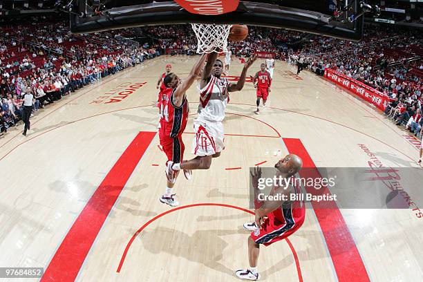 Aaron Brooks of the Houston Rockets shoots the ball over Trenton Hassell of the New Jersey Nets on March 13, 2010 at the Toyota Center in Houston,...