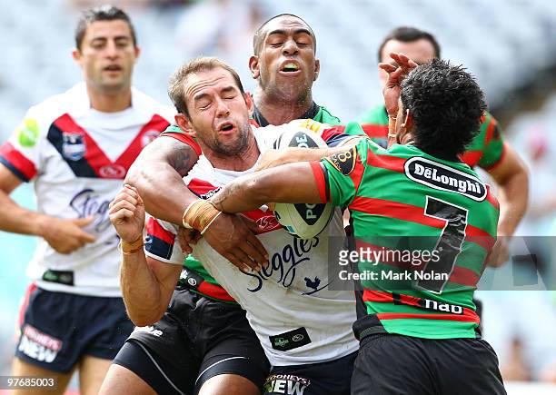 Phil Graham of the Roosters is tackled during the round one NRL match between the South Sydney Rabbitohs and the Sydney Roosters at ANZ Stadium on...