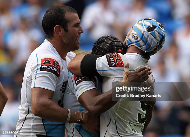 Preston Campbell of the Titans celebrates with team mates after scoring the match winning try during the round one NRL match between the Gold Coast...