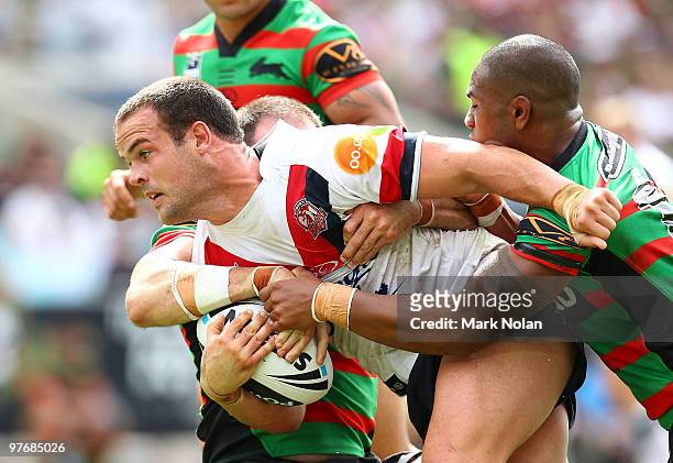 Nate Myles of the Roosters is tackled during the round one NRL match between the South Sydney Rabbitohs and the Sydney Roosters at ANZ Stadium on...