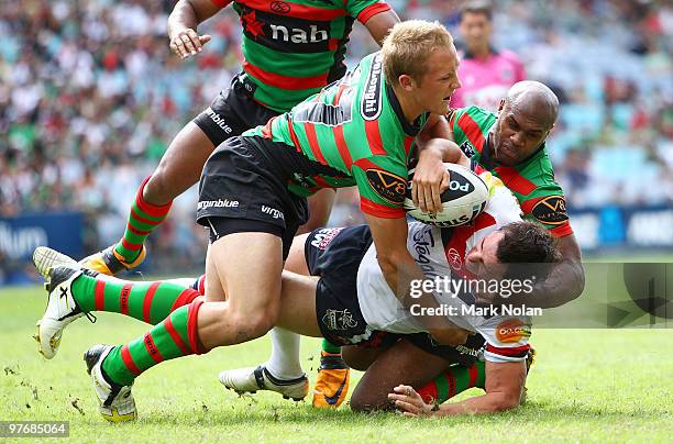 Mitchell Pearce of the Roosters is atckled during the round one NRL match between the South Sydney Rabbitohs and the Sydney Roosters at ANZ Stadium...