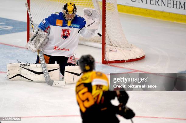 April 2018, Germany, Weisswasser: Ice hockey: International match, Germany vs Slovakia at the Eisarena Weisswasser. Germany's Stefan Loibl and...