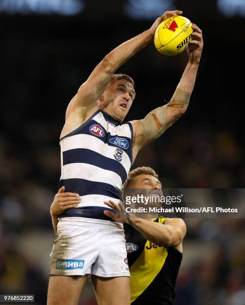 Joel Selwood of the Cats and Dan Butler of the Tigers compete for the ball during the 2018 AFL round 13 match between the Geelong Cats and the...