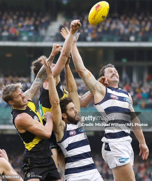Nathan Broad of the Tigers, Dylan Grimes of the Tigers, James Parsons of the Cats and Patrick Dangerfield of the Cats compete for the ball during the...