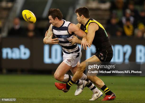 Patrick Dangerfield of the Cats and Trent Cotchin of the Tigers compete for the ball during the 2018 AFL round 13 match between the Geelong Cats and...