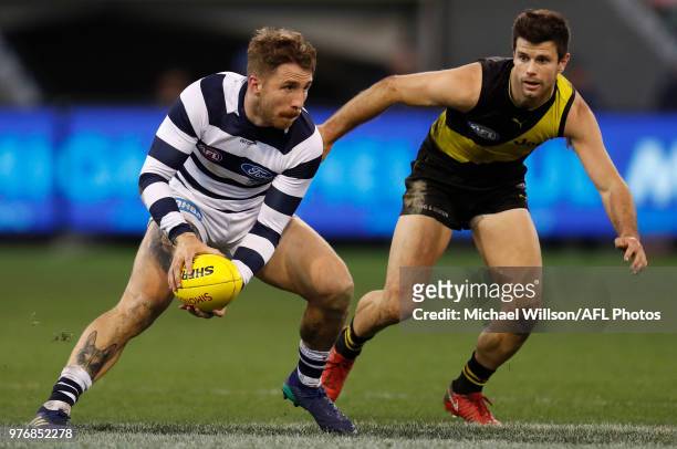 Zach Tuohy of the Cats and Trent Cotchin of the Tigers in action during the 2018 AFL round 13 match between the Geelong Cats and the Richmond Tigers...