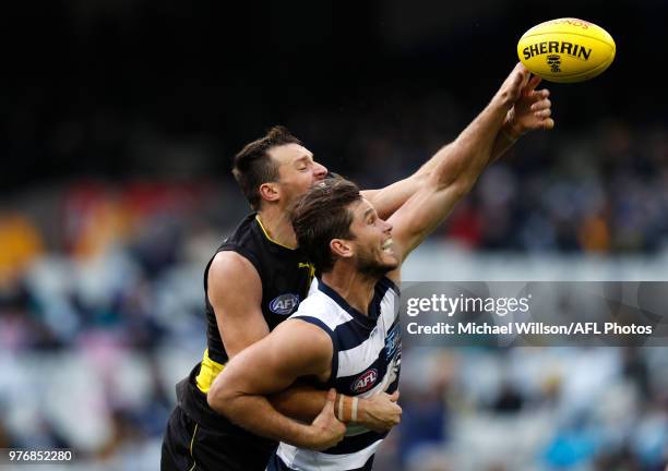 Tom Hawkins of the Cats and Toby Nankervis of the Tigers compete in a ruck contest during the 2018 AFL round 13 match between the Geelong Cats and...