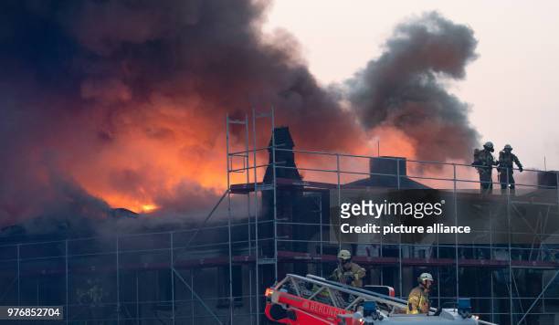 Dpatop - 14 April 2018, Germany, Berlin: Dense smoke rises from the hall of the former slaughterhouse at the Landsberger Allee. A fire broke out on...