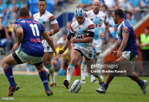 Nathan Friend of the Titans kicks the ball through the Warriors defensive line for team mate Preston Campbell to score during the round one NRL match...