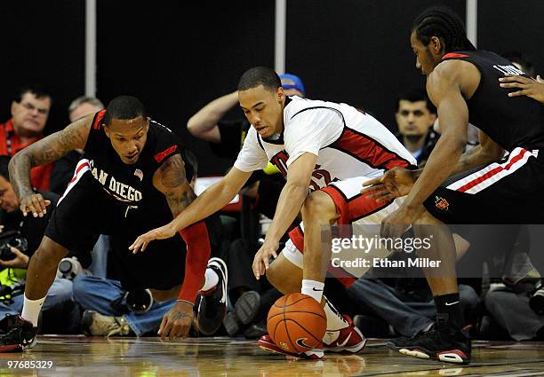 Billy White of the San Diego State Aztecs, Chace Stanback of the UNLV Rebels and Kawhi Leonard of the Aztecs go after a loose ball during the...