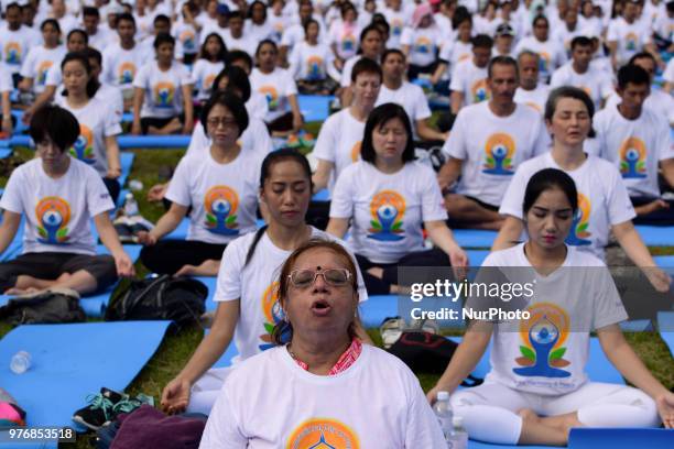 Thousands of people participate in a yoga exercise at Chulalongkorn University field, marking the International Day of Yoga in Bangkok, Thailand. 17...