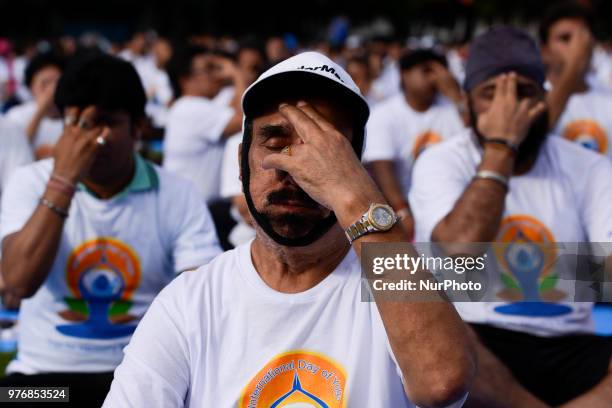 Thousands of people participate in a yoga exercise at Chulalongkorn University field, marking the International Day of Yoga in Bangkok, Thailand. 17...