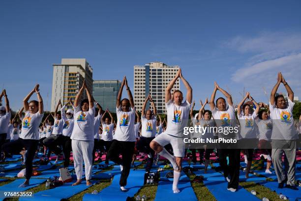 Thousands of people participate in a yoga exercise at Chulalongkorn University field, marking the International Day of Yoga in Bangkok, Thailand. 17...