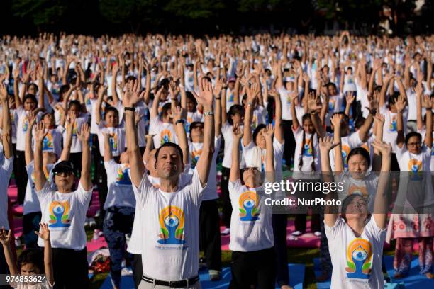 Thousands of people participate in a yoga exercise at Chulalongkorn University field, marking the International Day of Yoga in Bangkok, Thailand. 17...